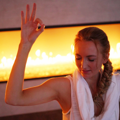 gyan mudra doing kundalini yoga near a fireplace